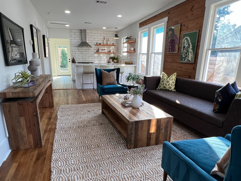 Modern living room flowing into white subway-tile kitchen