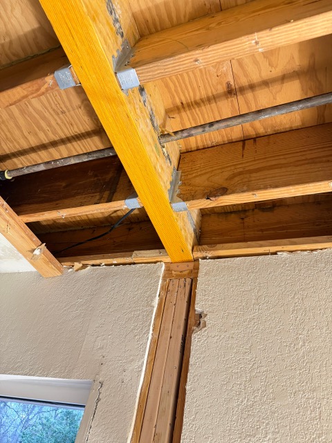 Bathroom renovation with exposed wall framing and tools