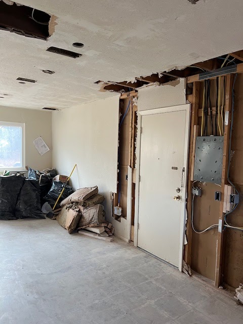 Active bathroom demolition with jackhammer and tile debris
