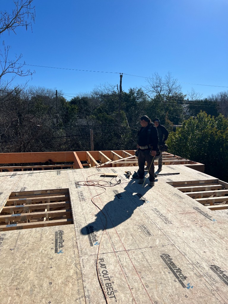 Crew installing AdvanTech subfloor on upper level